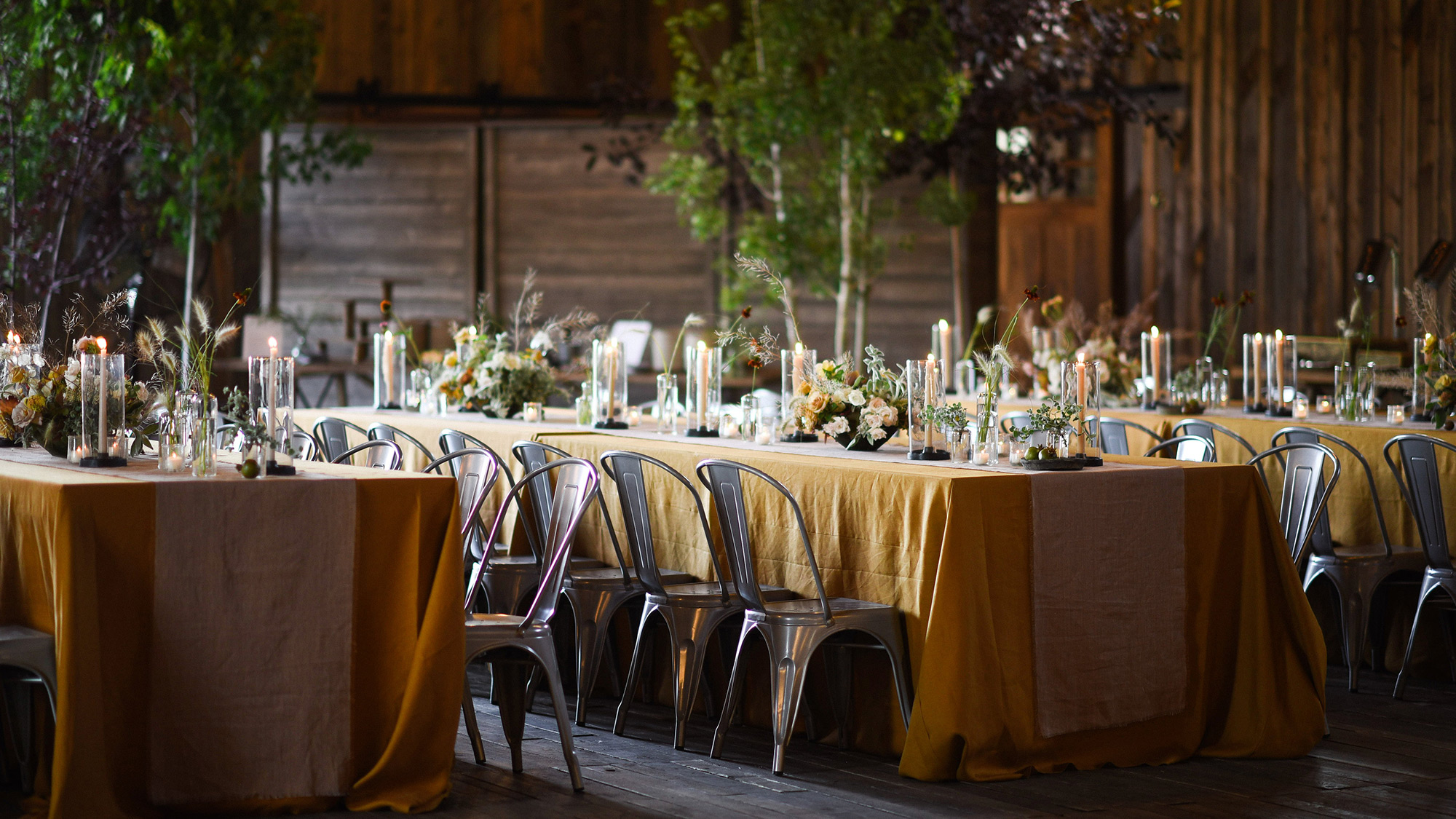 long wedding tables and chairs with flora decorations