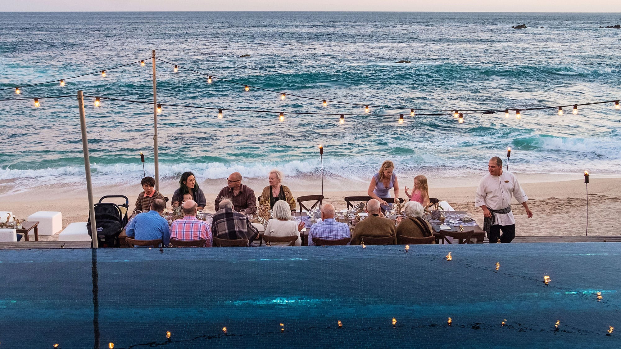 group of people dining on the beach