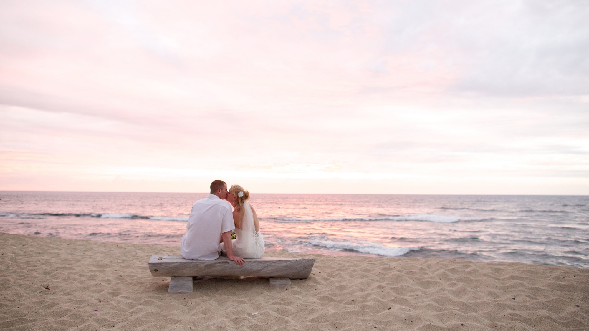 couple sit at the beach